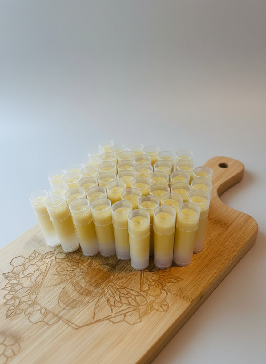 Multiple small containers filled with a yellow substance on a wooden board with a floral design.
